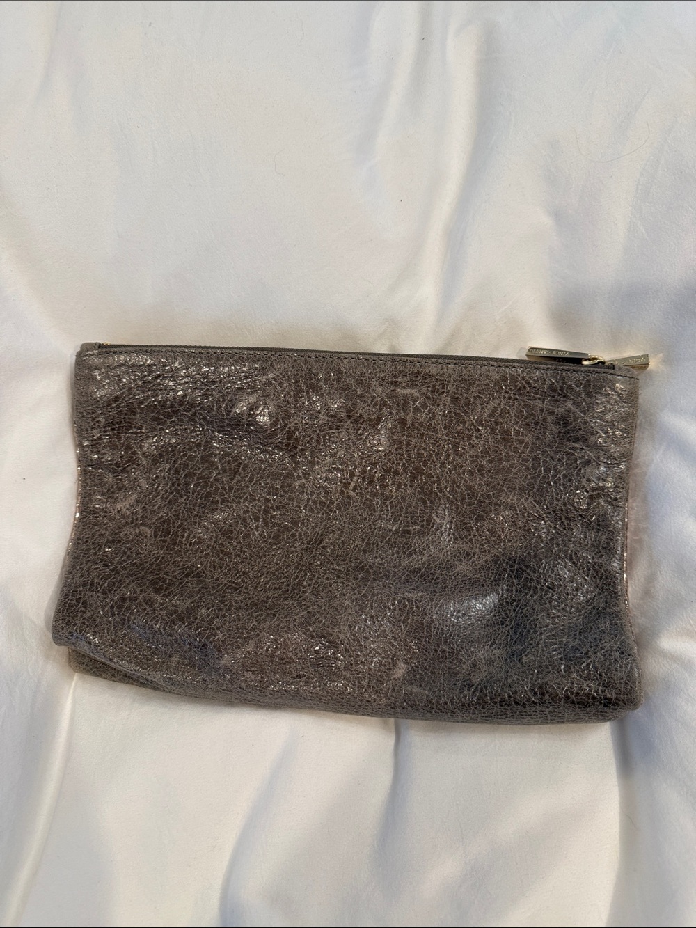 Leather Zip reversible clutch in Metallic taupe and reverses to rose gold